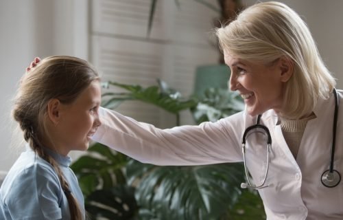 Side,View,Happy,Middle,Aged,Female,Pediatrician,In,White,Medical